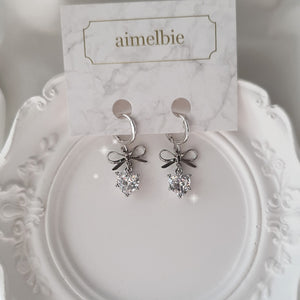 [IU Earrings] Dainty Heart Crystal and Ribbon Huggies Earrings - Silver Color
