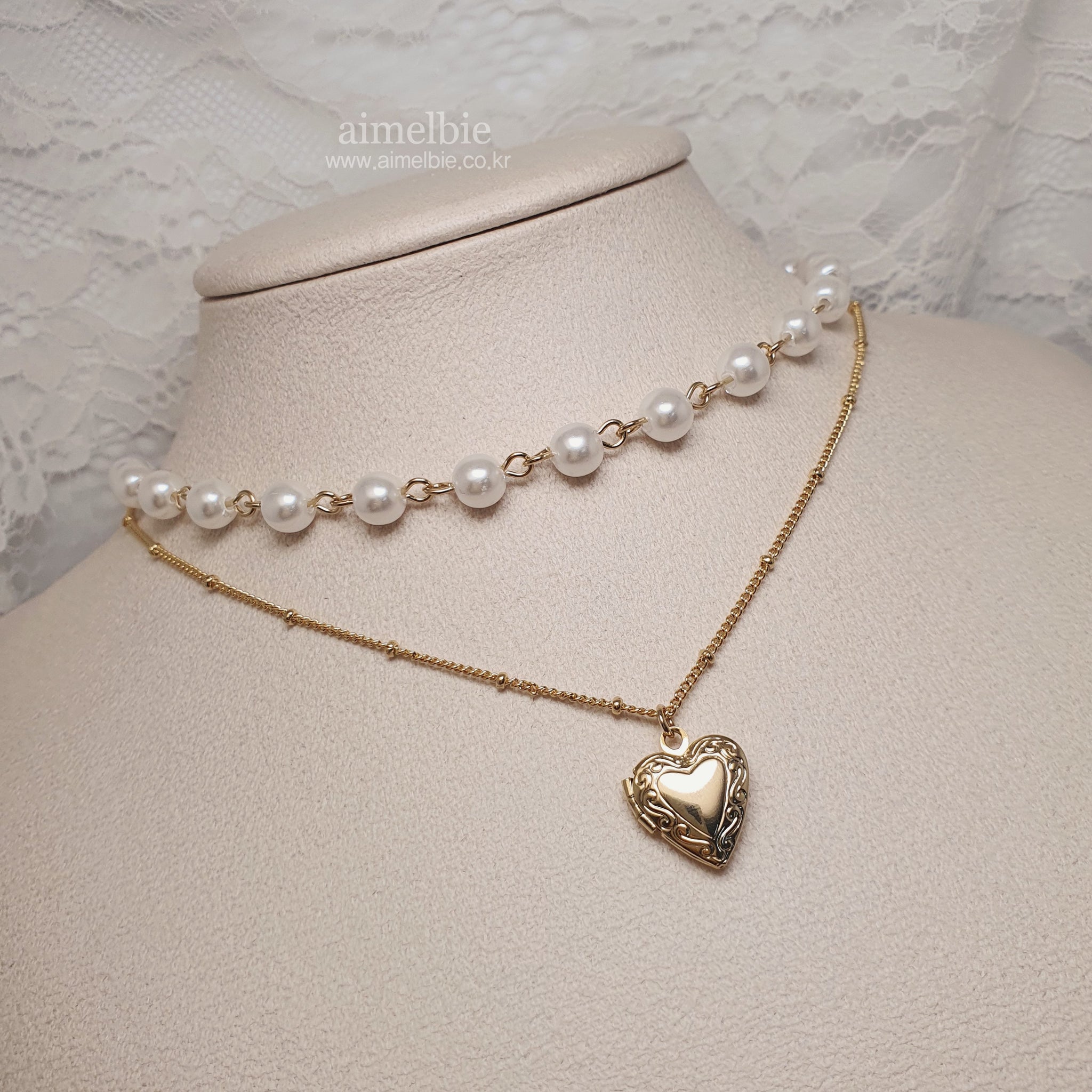 Pearl necklace sales with heart locket